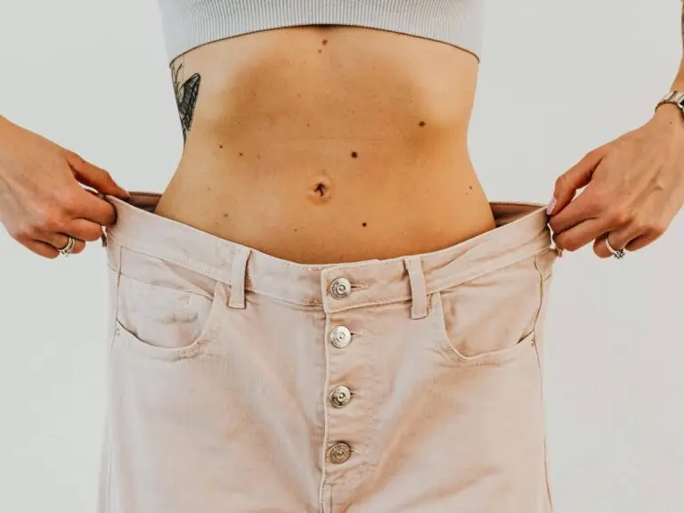 Close-up of a woman showing weight loss progress after pregnancy, symbolizing recovery from hormonal imbalance.