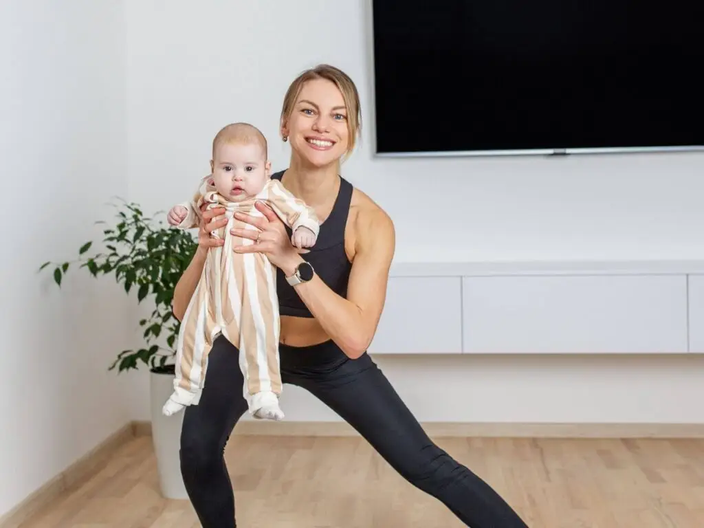 Mother exercising at home with her baby, promoting postpartum wellness and hormone balance recovery.