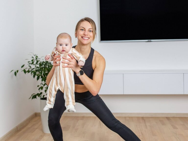 Mother exercising at home with her baby, promoting postpartum wellness and hormone balance recovery.